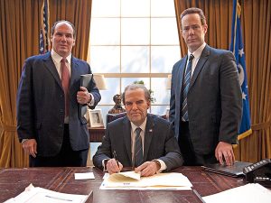 Harry Shearer as Richard Nixon sitting at desk in the oval office