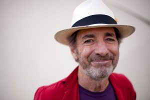 Harry Shearer wearing a white hat